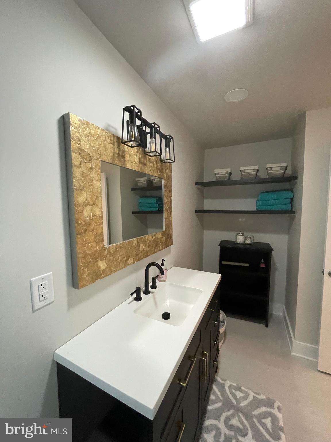 3 Talbot Avenue Cambridge, MD 21613 - Photo 9 of 17 a bathroom with a sink and a mirror