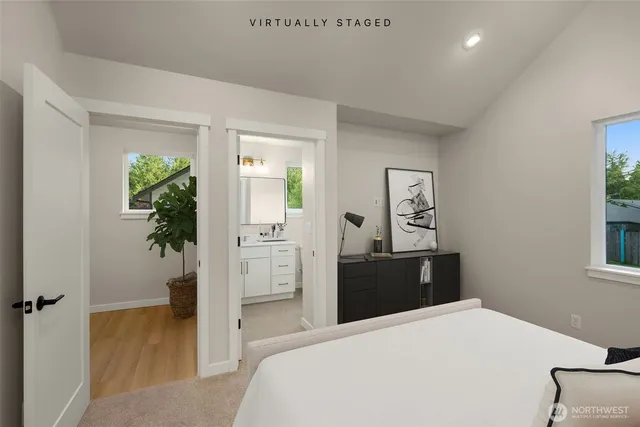 a bedroom with a bed and a potted plant