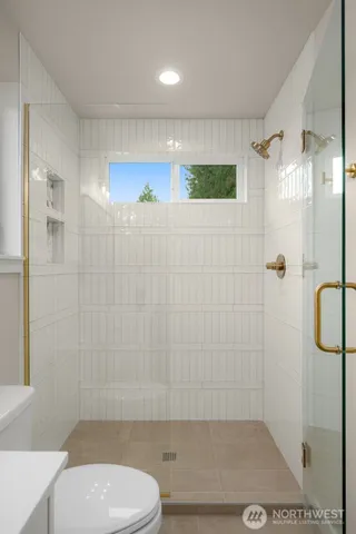 a bathroom with a shower and a toilet