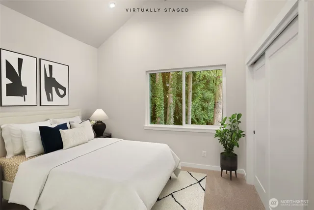 a bed room with two beds and a potted plant