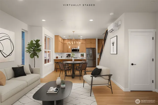 a living room with furniture kitchen view and a potted plant