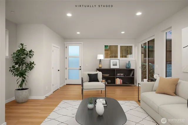 a living room with furniture and a potted plant