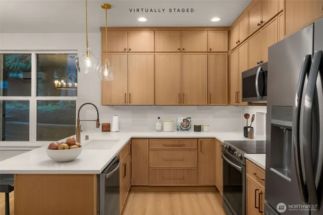 a kitchen with stainless steel appliances granite countertop a sink stove and refrigerator