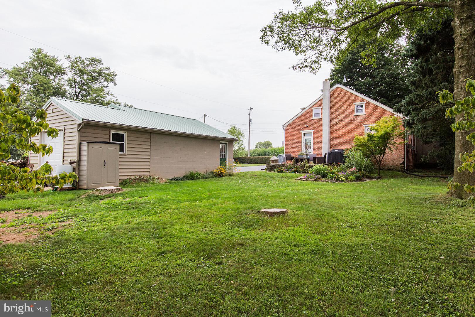317 West Meadow Valley Road Lititz, PA 17543 - Photo 51 of 59 a backyard of a house with plants and large tree