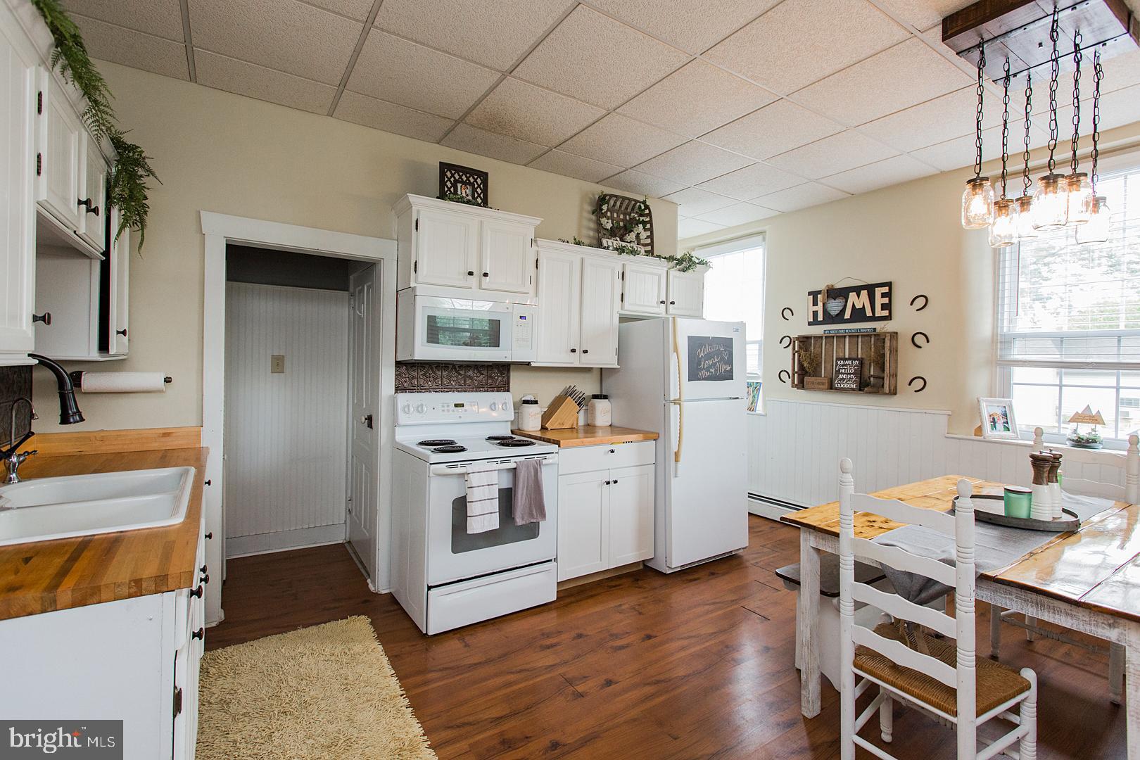 317 West Meadow Valley Road Lititz, PA 17543 - Photo 8 of 59 a kitchen with stainless steel appliances a stove a sink dishwasher a refrigerator white cabinets and wooden floor