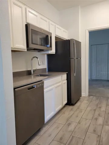 a kitchen with a sink and steel stainless steel appliances