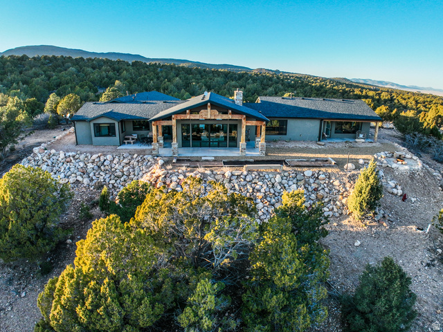 6688 Bareback Road Cedar City, UT 84720 - Photo 5 of 58 Back of property featuring a patio area, a chimney, a view of trees, a mountain view, and stucco siding