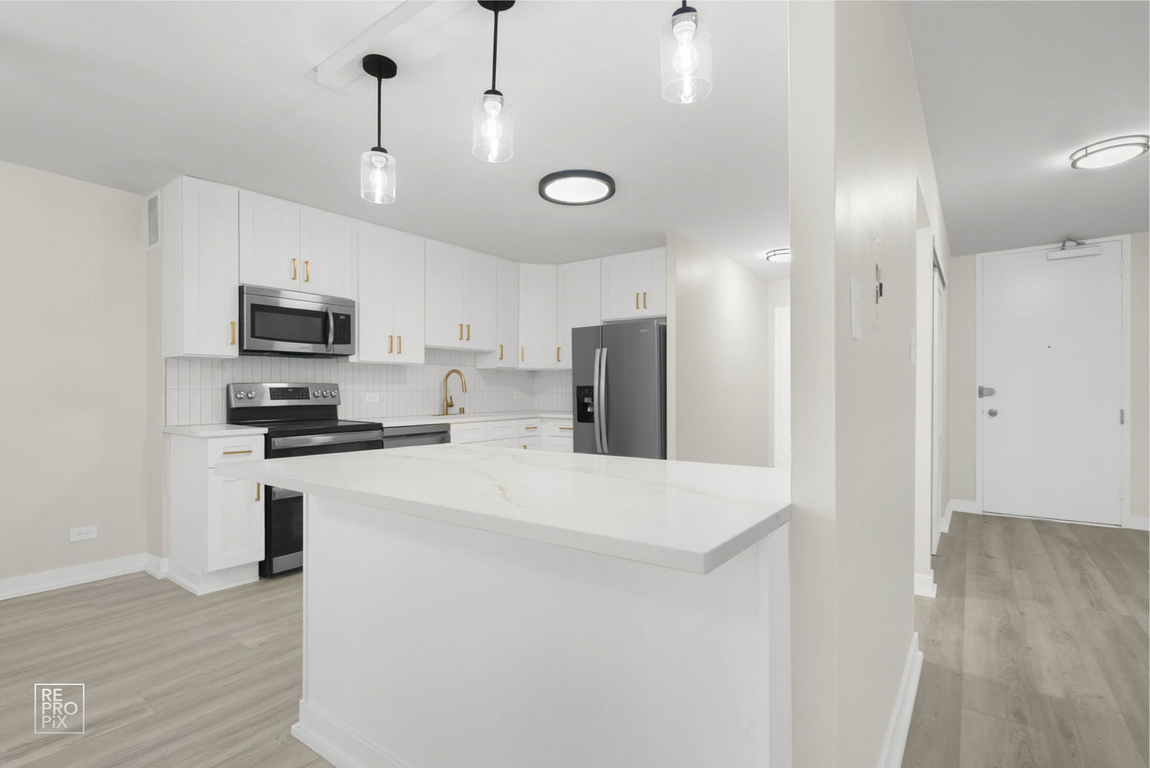 6147 North Sheridan Road, Unit 7A Chicago, IL 60660 - Photo 4 of 14 a kitchen with stainless steel appliances granite countertop a refrigerator a stove a microwave oven a sink dishwasher and a refrigerator with wooden floor