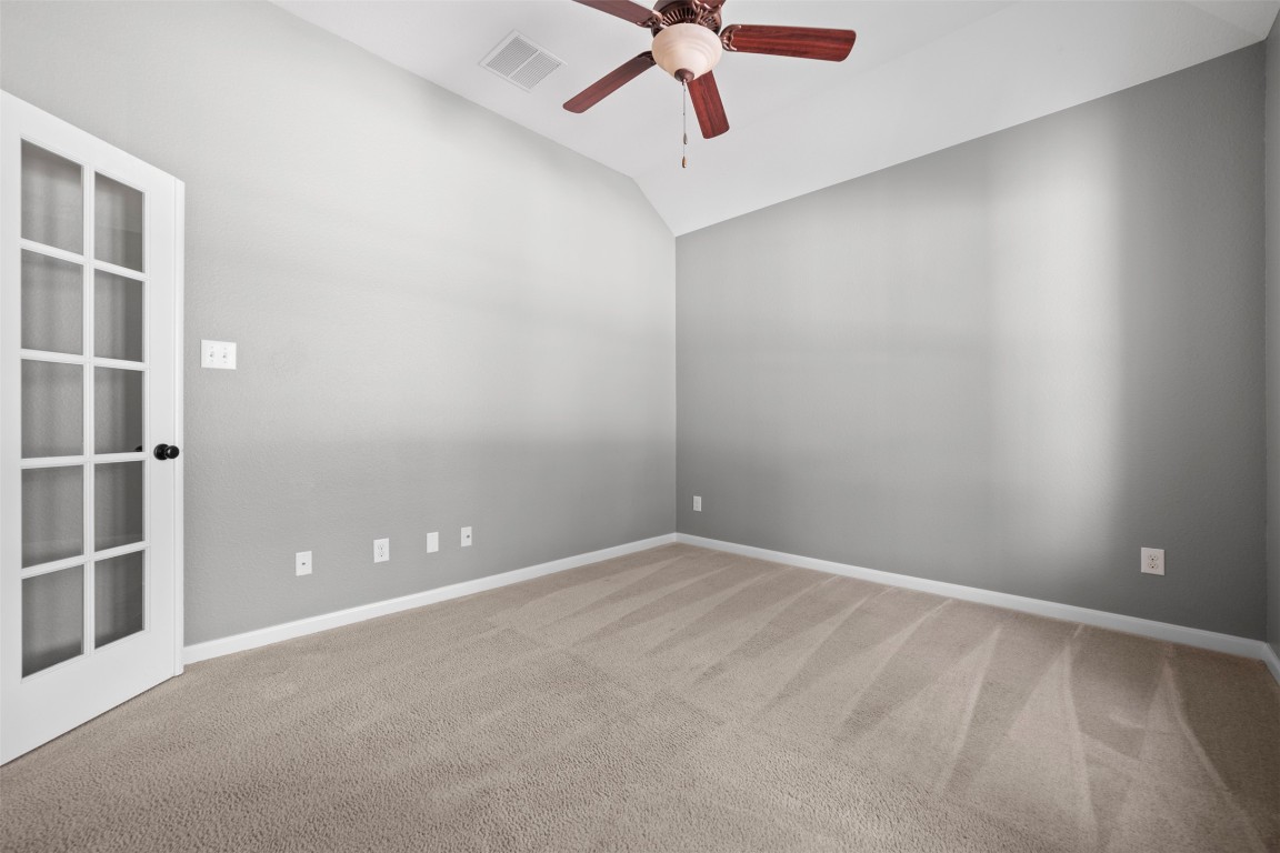 216 Archipelago Trail Austin, TX 78717 - Photo 25 of 40 Empty room with a ceiling fan, carpet floors, and vaulted ceiling