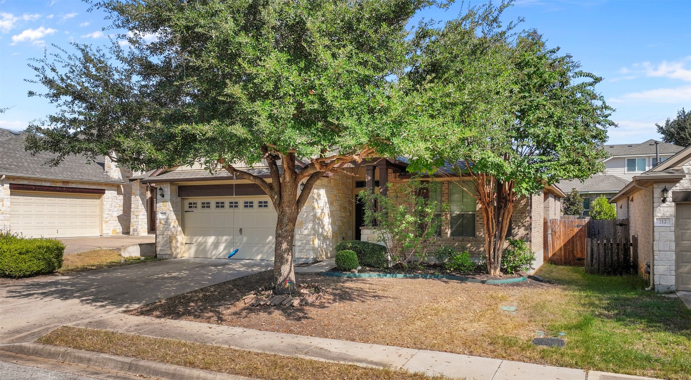 216 Archipelago Trail Austin, TX 78717 - Photo 3 of 40 View of front facade with stone siding and concrete driveway