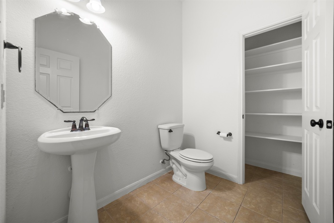 216 Archipelago Trail Austin, TX 78717 - Photo 31 of 40 Bathroom with light tile patterned floors, a textured wall, and a closet