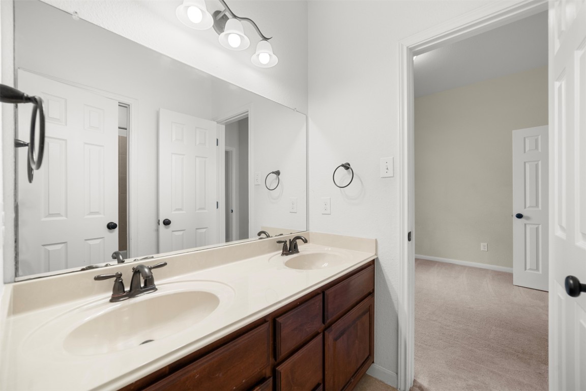 216 Archipelago Trail Austin, TX 78717 - Photo 32 of 40 Full bath featuring double vanity and baseboards