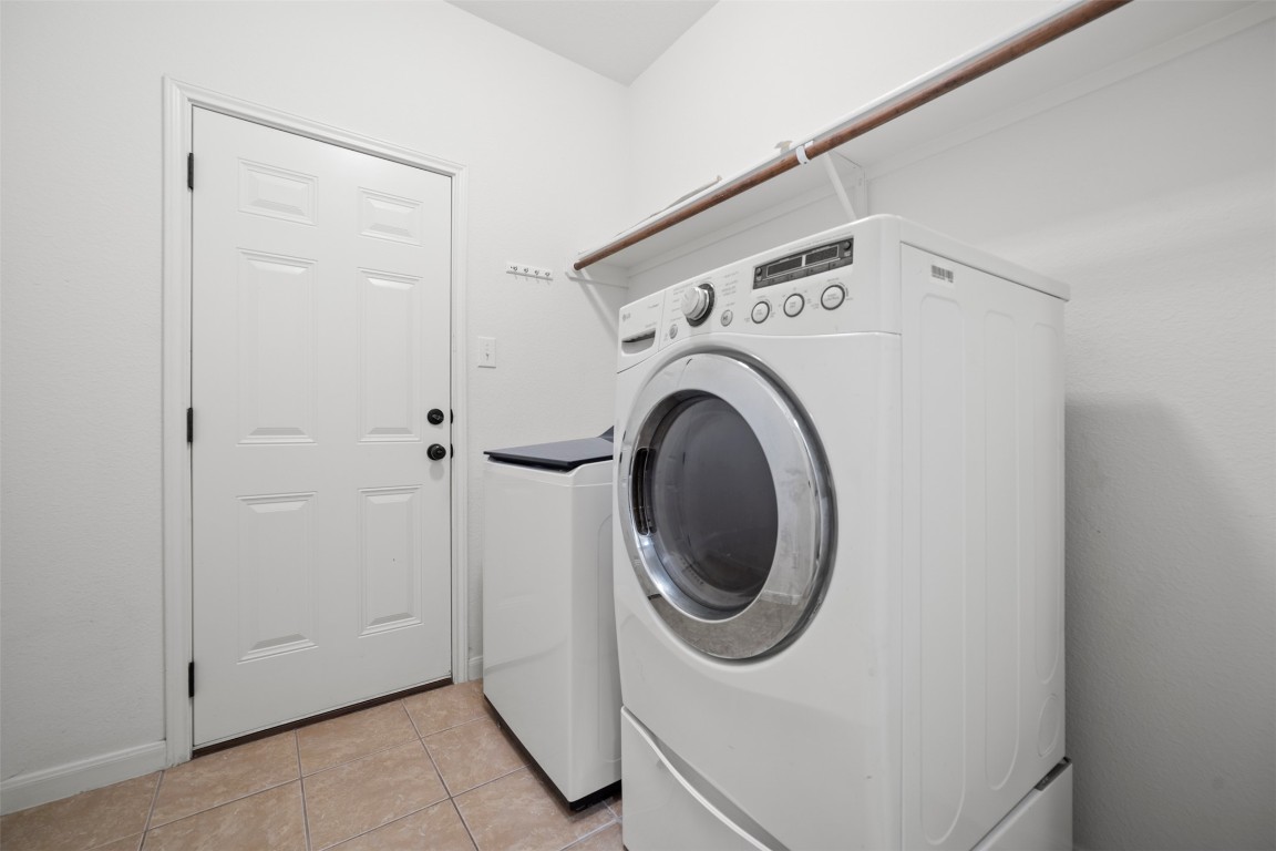 216 Archipelago Trail Austin, TX 78717 - Photo 34 of 40 Laundry room featuring light tile patterned floors and washing machine and dryer