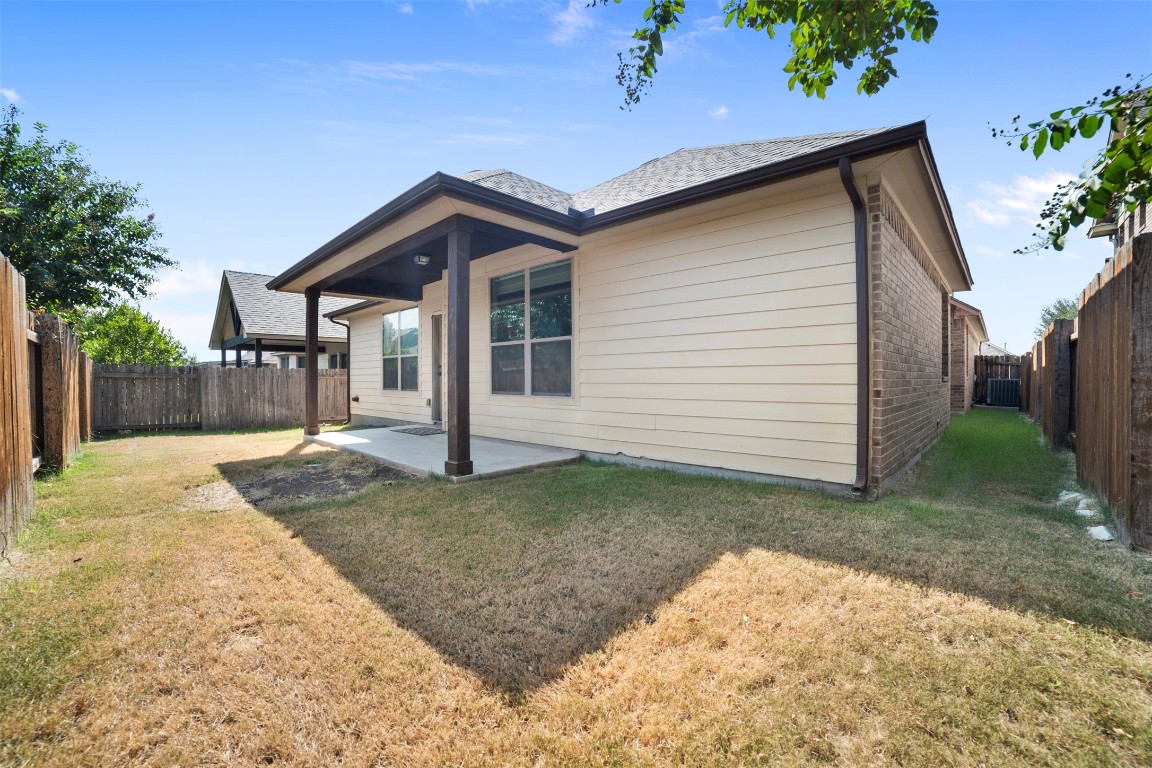 216 Archipelago Trail Austin, TX 78717 - Photo 38 of 40 Back of house with a fenced backyard, a patio area, and roof with shingles