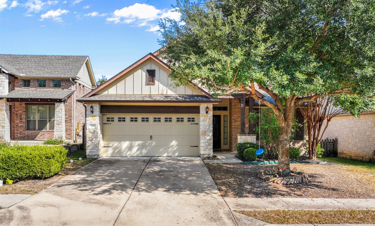 216 Archipelago Trail Austin, TX 78717 - Photo 4 of 40 View of front of house with board and batten siding, stone siding, concrete driveway, and an attached garage