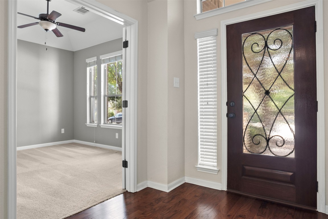 216 Archipelago Trail Austin, TX 78717 - Photo 5 of 40 Carpeted entryway featuring wood finished floors and a ceiling fan