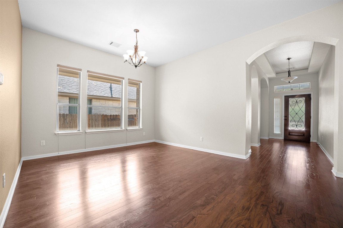 216 Archipelago Trail Austin, TX 78717 - Photo 7 of 40 Entrance foyer with dark wood-type flooring, arched walkways, and a chandelier