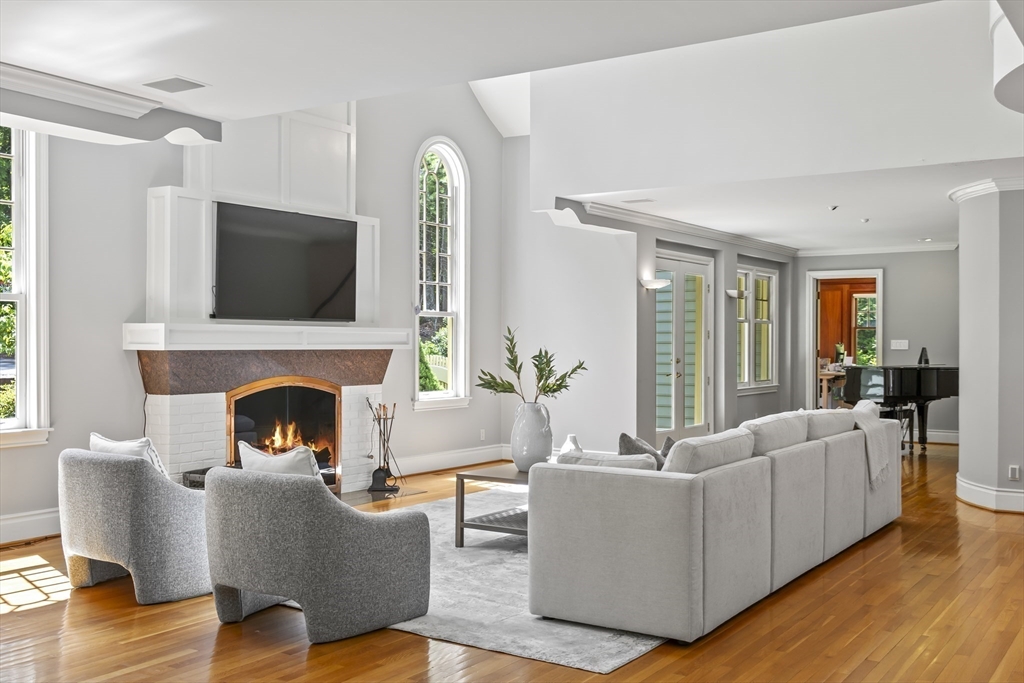 52 Goodnow Road Sudbury, MA 01776 - Photo 8 of 42 a living room with furniture a fireplace and a flat screen tv