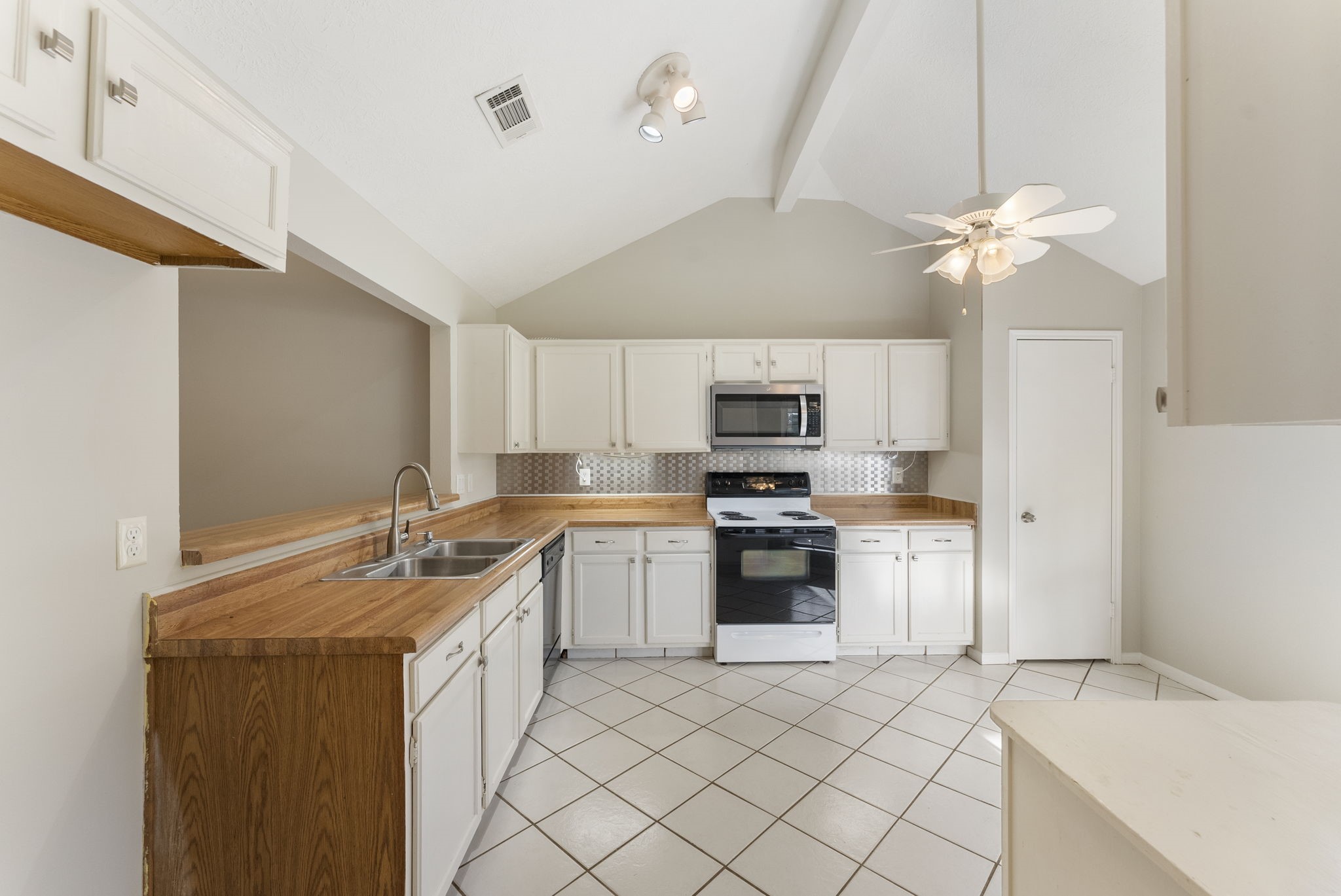 5114 Aberton Lane Spring, TX 77379 - Photo 11 of 31 a kitchen with stainless steel appliances a stove a sink and a refrigerator