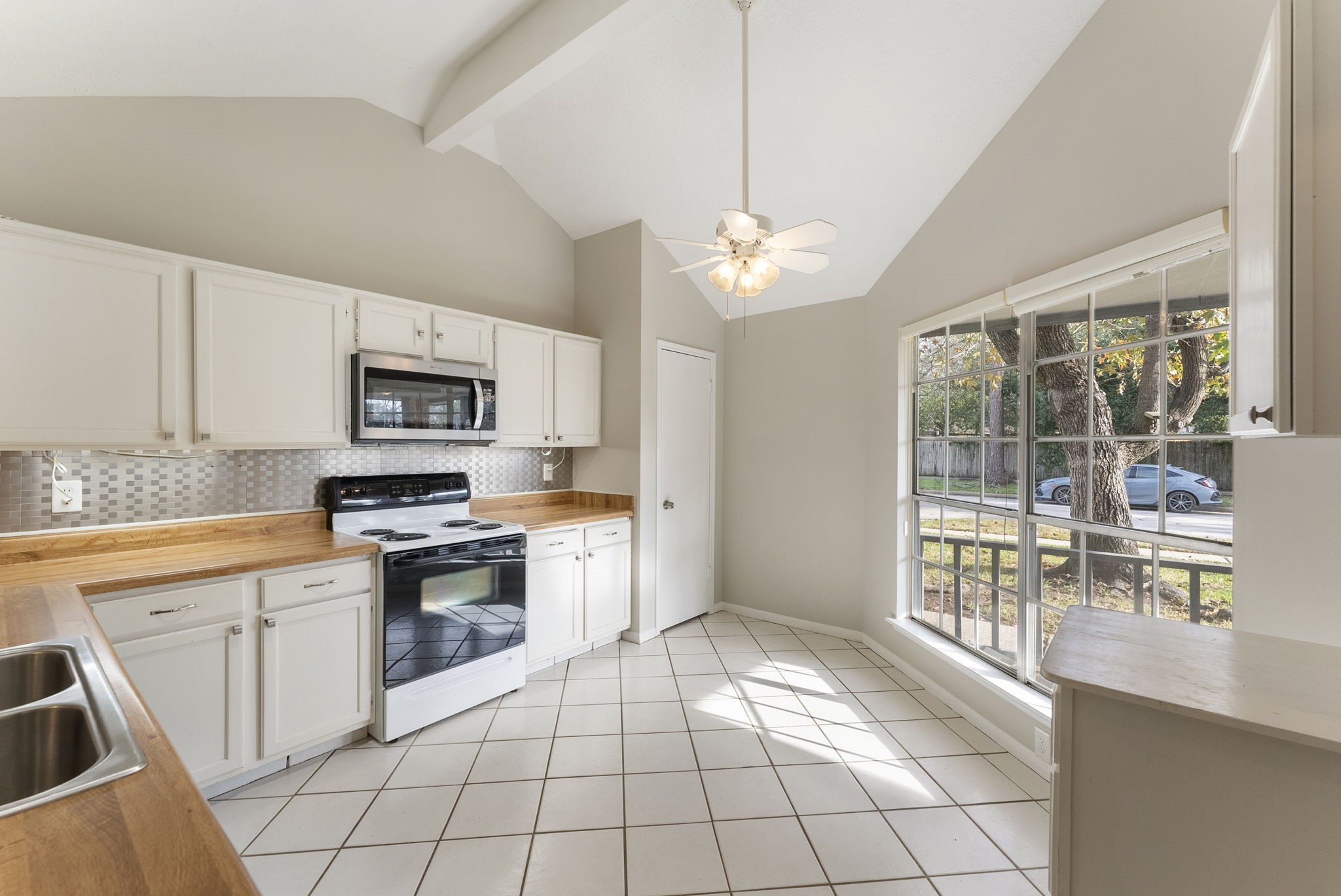 5114 Aberton Lane Spring, TX 77379 - Photo 12 of 31 a kitchen with stainless steel appliances a stove sink and microwave