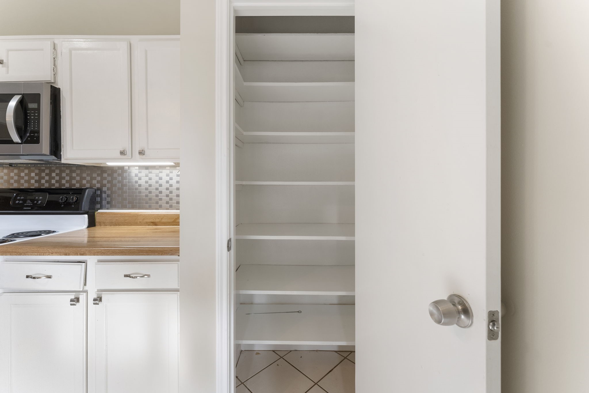 5114 Aberton Lane Spring, TX 77379 - Photo 14 of 31 a view of kitchen with cabinets and a refrigerator