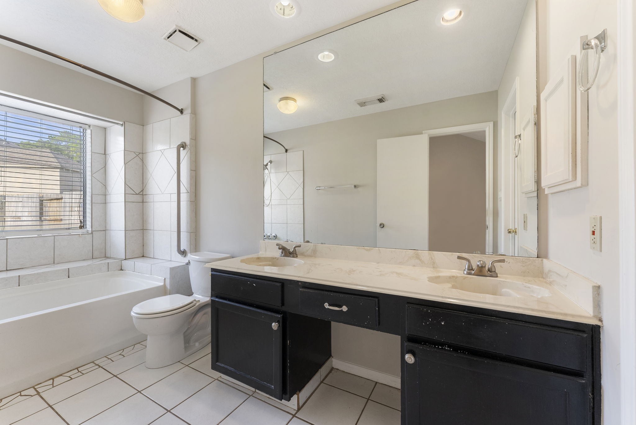 5114 Aberton Lane Spring, TX 77379 - Photo 16 of 31 a bathroom with a granite countertop double vanity sink a mirror and a bathtub