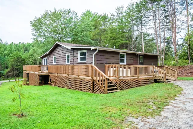 a view of a house with a yard and sitting area