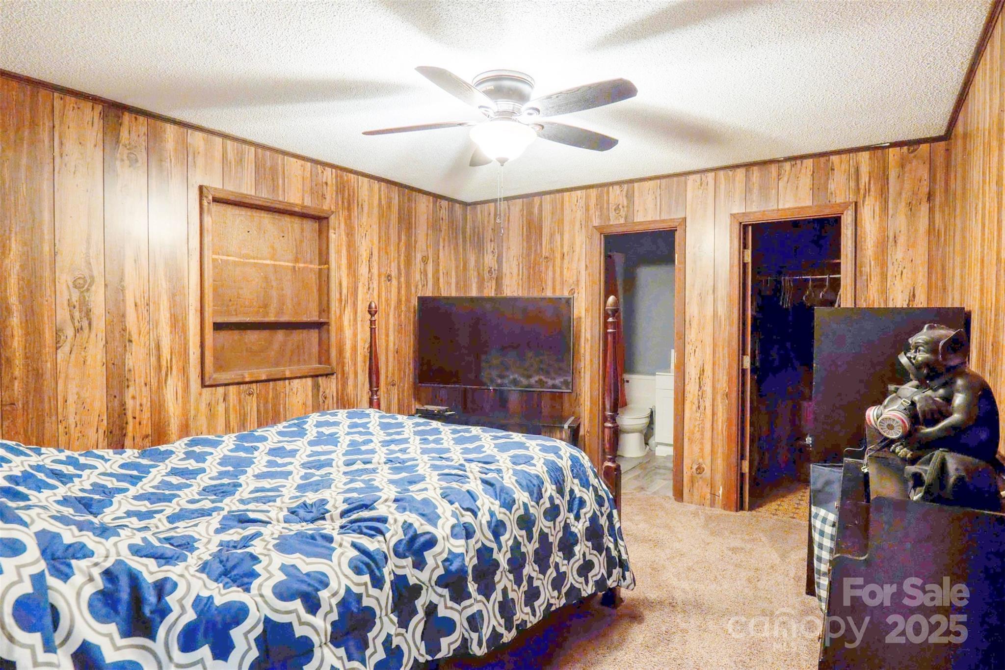 4420 Highway 64 Rutherfordton, NC 28139 - Photo 16 of 35 a bedroom with a bed and a chandelier