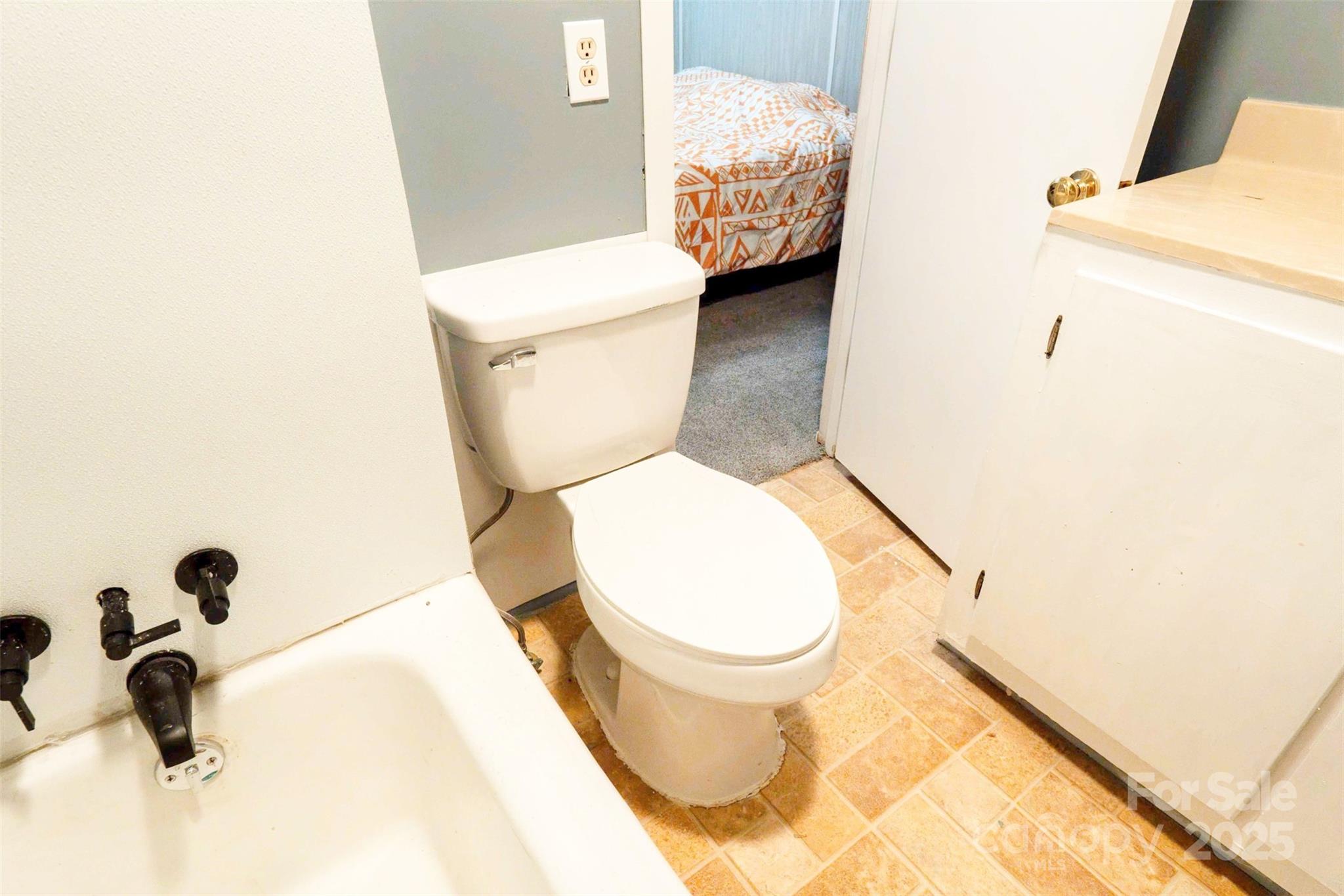 4420 Highway 64 Rutherfordton, NC 28139 - Photo 22 of 35 a white toilet sitting next to a bathroom sink