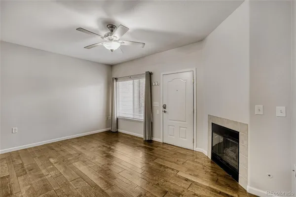 wooden floor in an empty room with a fireplace