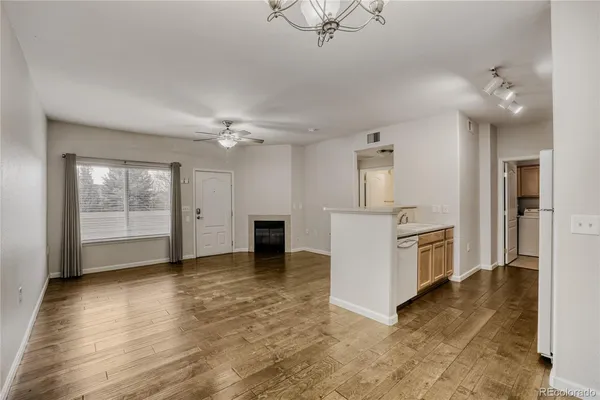a view of a kitchen with furniture and wooden floor