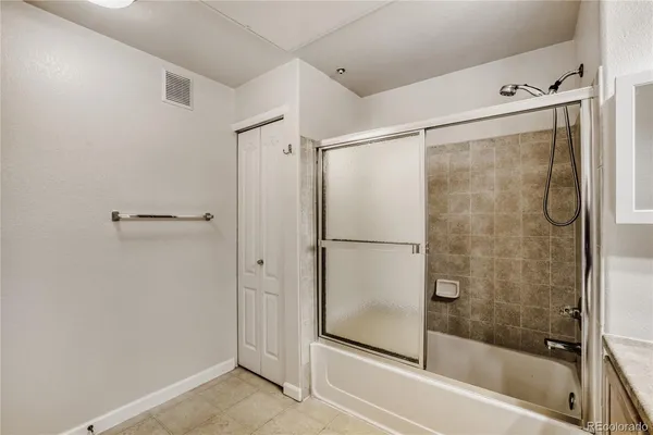 a bathroom with a glass shower door