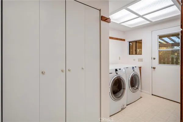 an aerial view of a city with lots of residential buildings ocean and mountain view in back
