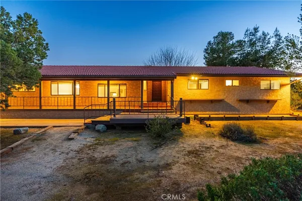 a view of a dining room with furniture and a window