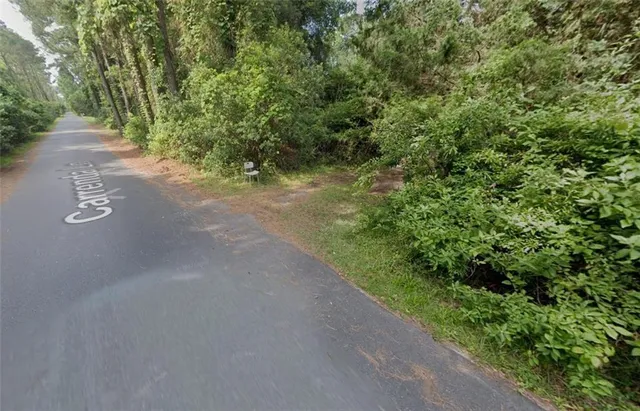 a view of a road with a yard