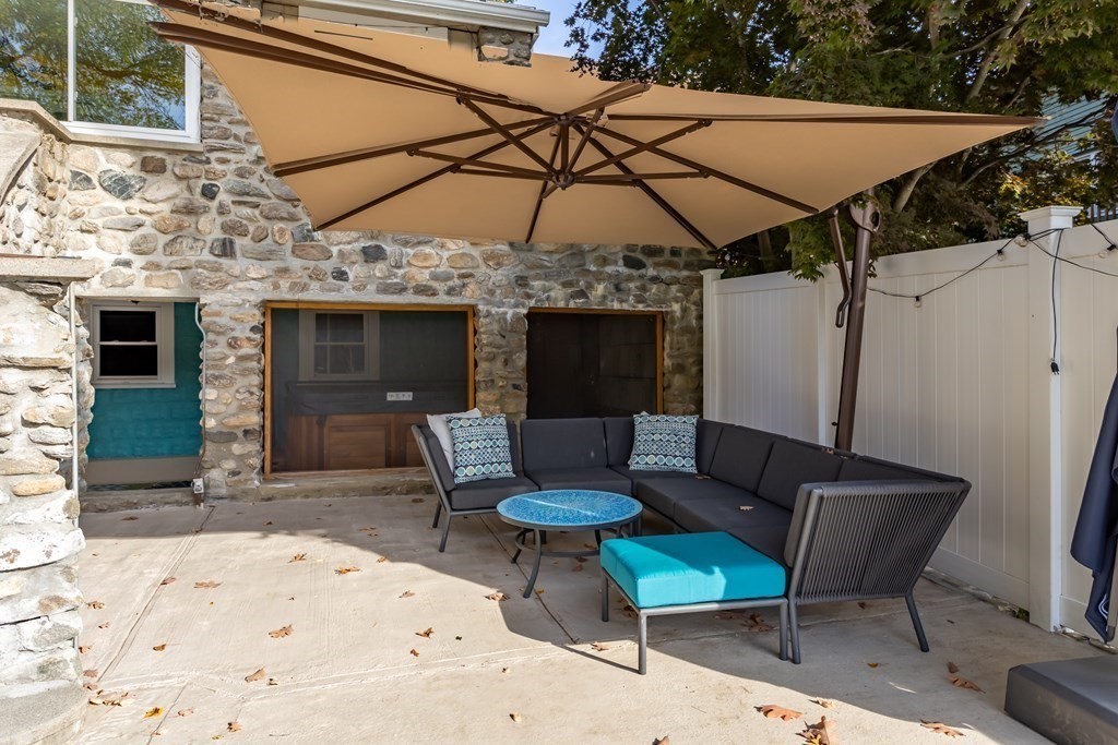 30 Davis Road Stow, MA 01775 - Photo 34 of 42 a patio with a table and chairs