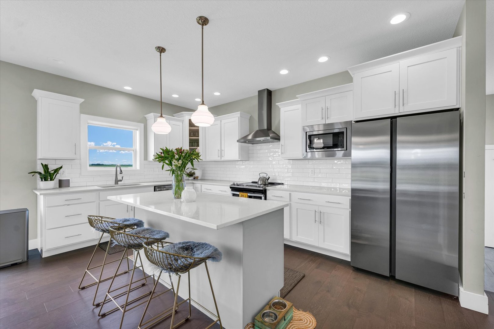 1908 Littlefield Lane Mahomet, IL 61853 - Photo 13 of 51 a kitchen with stainless steel appliances kitchen island a refrigerator a stove a sink and white cabinets