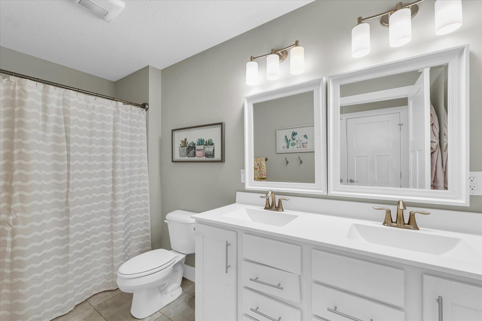 1908 Littlefield Lane Mahomet, IL 61853 - Photo 39 of 51 a bathroom with a toilet a sink a mirror a vanity and shower