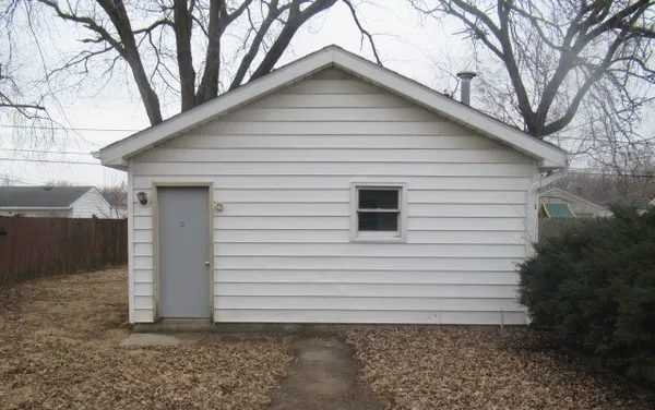 a view of a white house with a small yard