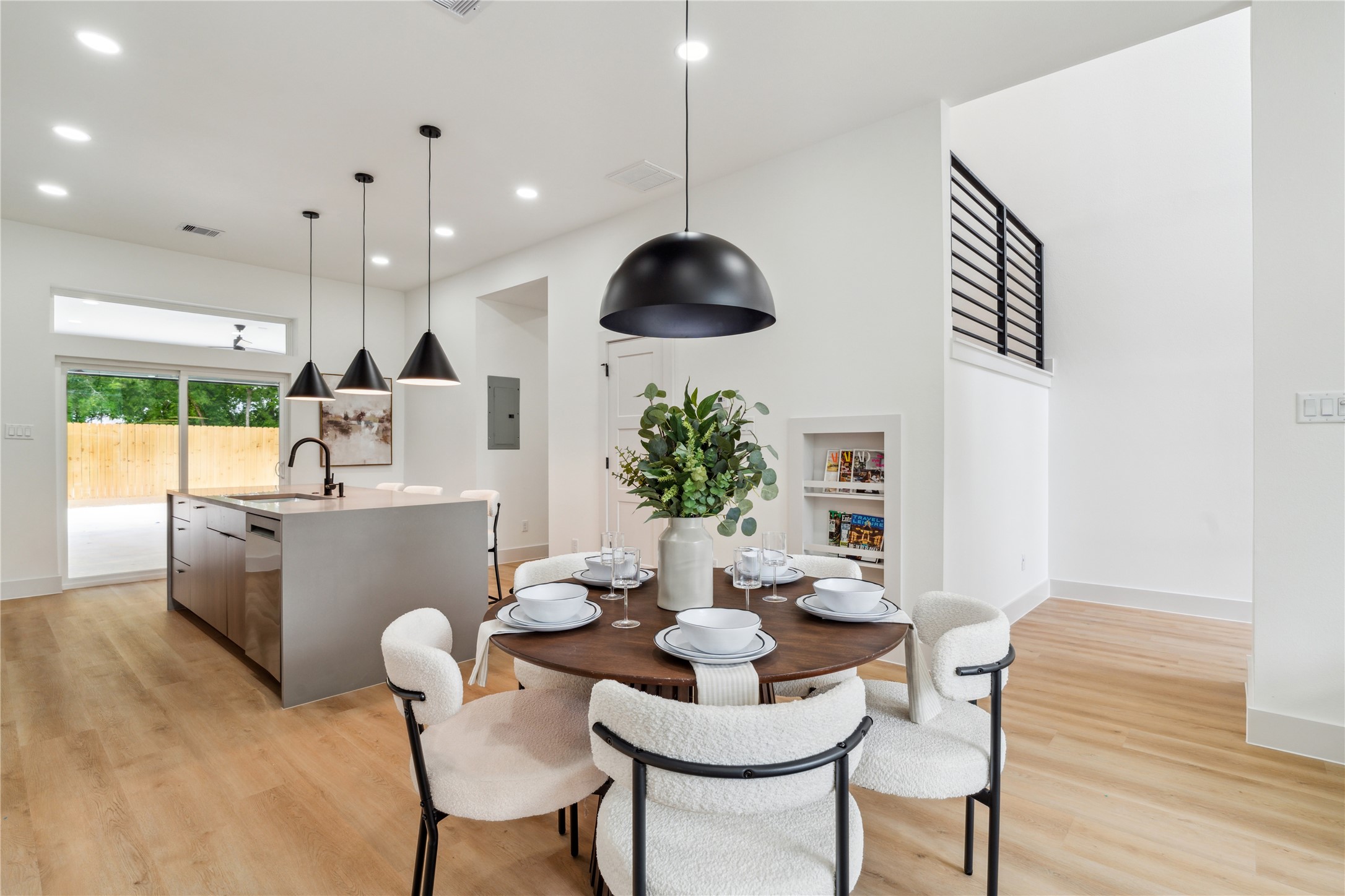 3415 Stonewall Street Houston, TX 77020 - Photo 11 of 50 Thoughtful details like a built-in display nook and oversized sliding doors enhance this bright, open layout—balancing modern style with everyday function.