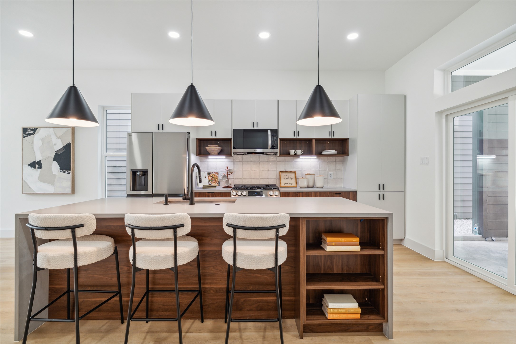 3415 Stonewall Street Houston, TX 77020 - Photo 14 of 50 This statement island isn’t just a showpiece—it features built-in shelving for added function and generous seating space for effortless gatherings and everyday convenience.