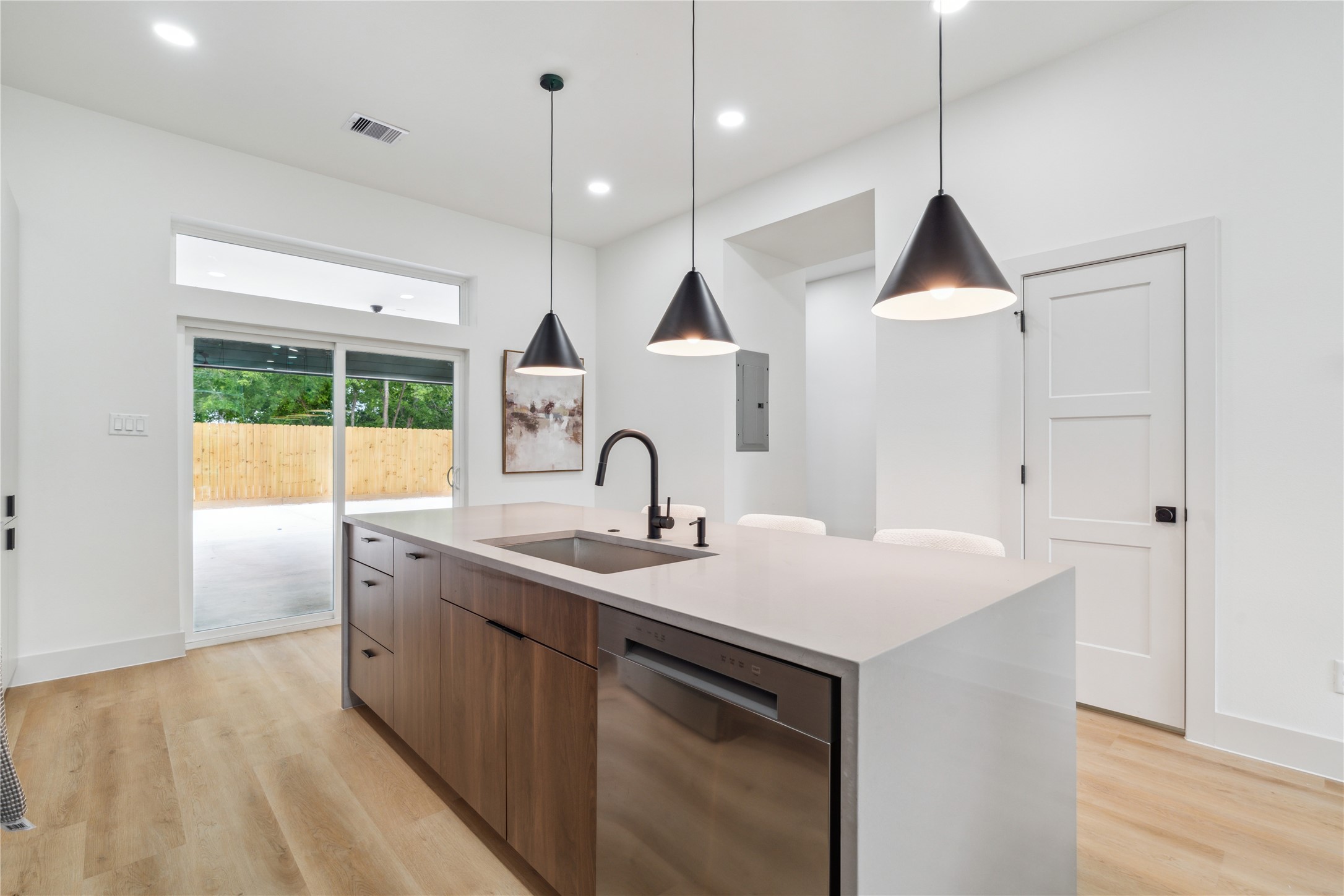 3415 Stonewall Street Houston, TX 77020 - Photo 19 of 50 Earth-toned cabinetry pairs seamlessly with sleek countertops and modern lighting to create a balanced, high-design aesthetic that feels both grounded and refined.