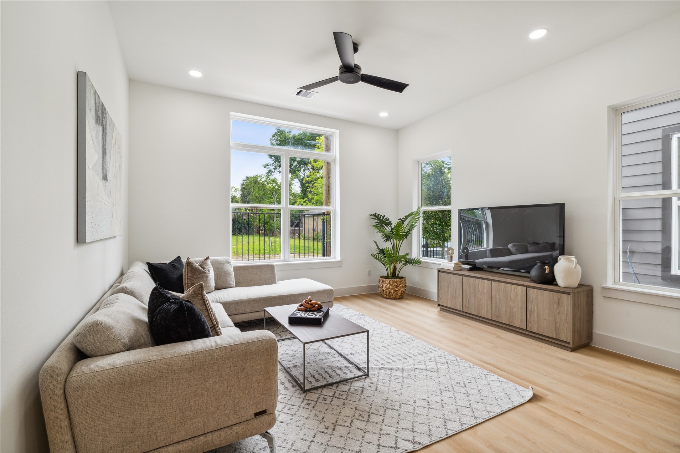 3415 Stonewall Street Houston, TX 77020 - Photo 21 of 50 Framed by tall windows and clean lines, the living room delivers natural light and backyard views—bringing comfort and connection into everyday moments.