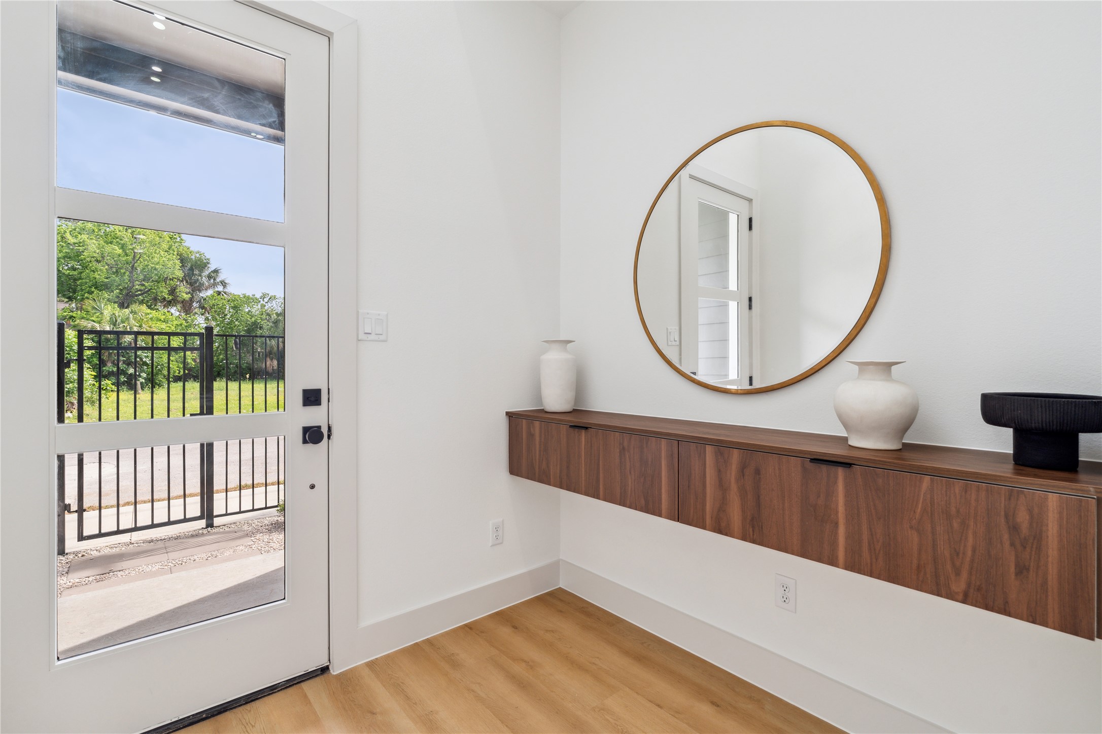 3415 Stonewall Street Houston, TX 77020 - Photo 8 of 50 Transom-style glass panels and floating cabinetry create an airy, light-filled entry that feels both grounded and effortlessly stunning.