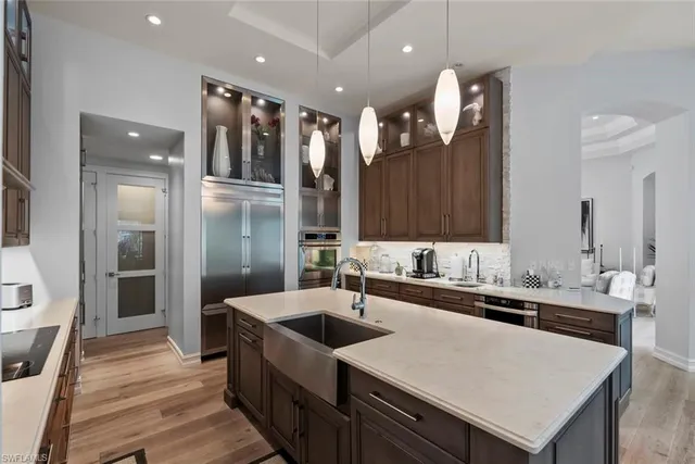 a kitchen with stainless steel appliances a sink and a refrigerator