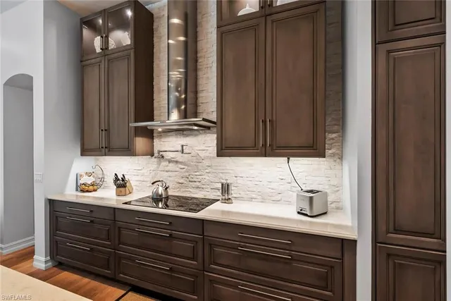 a kitchen with a table chairs sink and cabinets