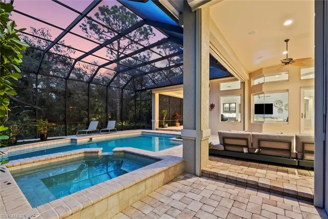 a large swimming pool with a table and chairs in balcony