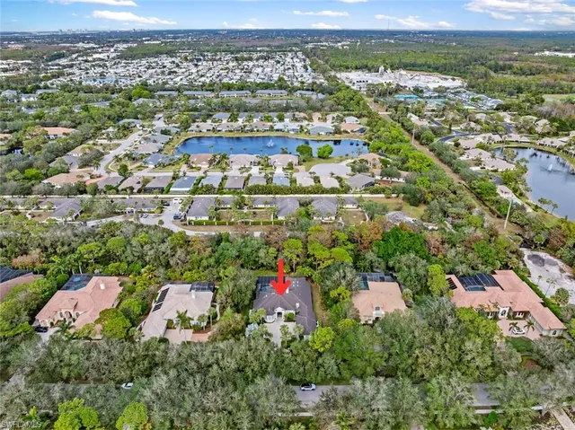 an aerial view of a house with plants and large trees