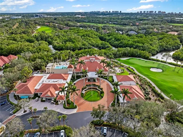 an aerial view of residential houses with outdoor space and trees