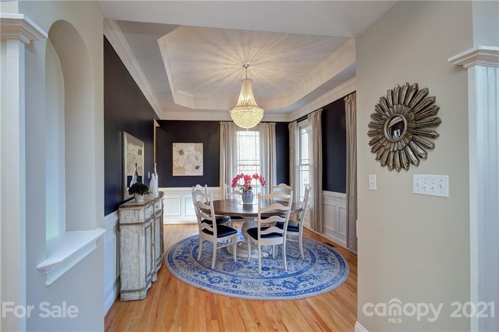 293 Point Carpenter Road Indian Land, SC 29707 - Photo 9 of 46 a dining room with furniture a chandelier and wooden floor